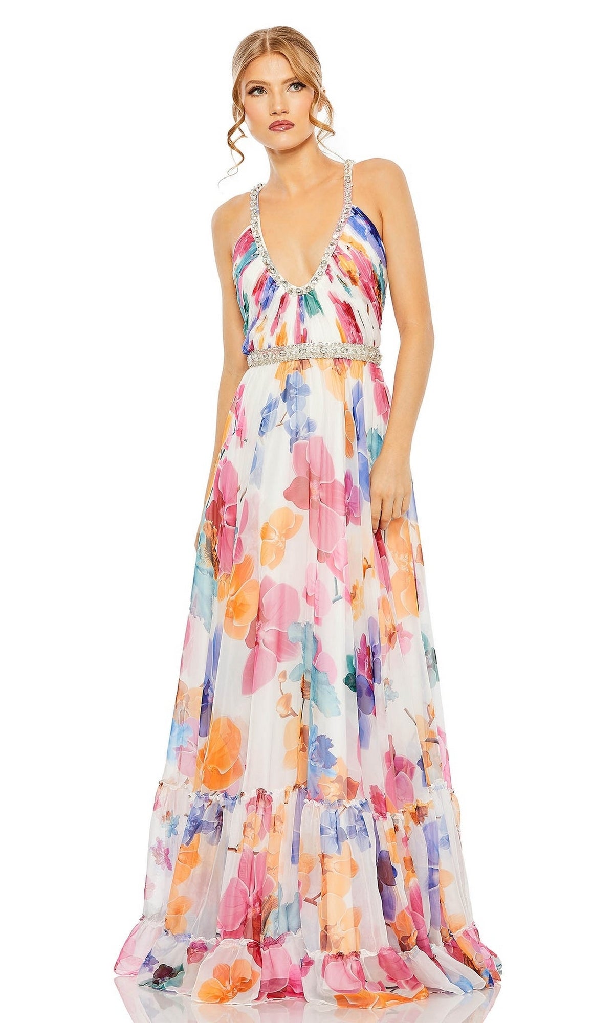 A woman models the Long Formal Dress 2219 by Mac Duggal, a sleeveless V-neck floral A-line gown with a beaded belt, standing against a plain white background.
